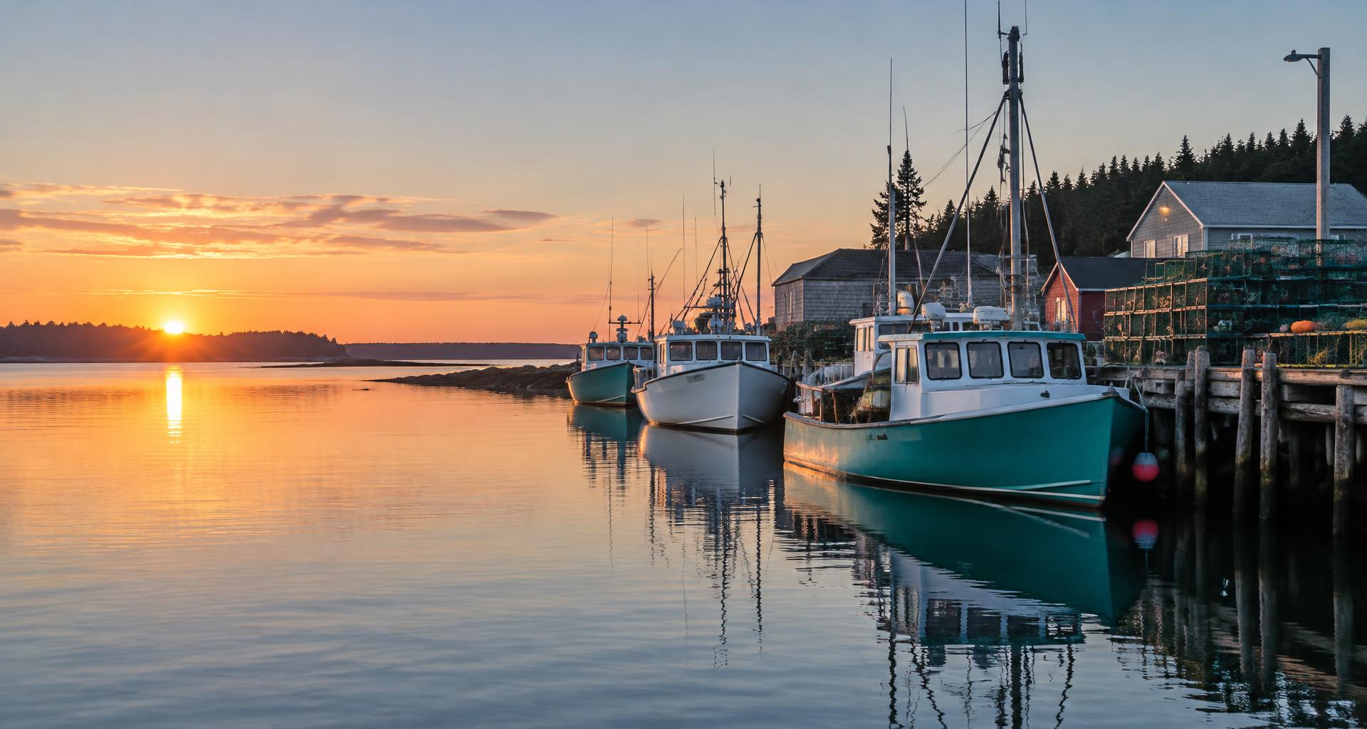 Atlantic fishing boats moored beside lobster traps at dawn